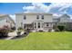 Beautiful backyard featuring a patio with a pergola, landscaping, and ample green space for outdoor enjoyment at 4915 Juniper Grove Sw Ct, Concord, NC 28027
