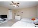 Bright bedroom with two twin beds, a ceiling fan, and a window at 4915 Juniper Grove Sw Ct, Concord, NC 28027