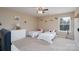 Bright bedroom with two twin beds, a ceiling fan, and a window at 4915 Juniper Grove Sw Ct, Concord, NC 28027