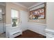 Inviting entryway with hardwood floors, white wainscoting, and a charming window seat at 4915 Juniper Grove Sw Ct, Concord, NC 28027