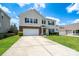 Charming two-story home featuring a well-maintained lawn and a two-car garage on a sunny day at 4915 Juniper Grove Sw Ct, Concord, NC 28027