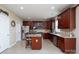 Well-lit kitchen with stainless steel appliances, granite counters and spacious center island at 4915 Juniper Grove Sw Ct, Concord, NC 28027