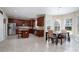Spacious kitchen with dark wood cabinets, stainless steel appliances, and a dining area at 4915 Juniper Grove Sw Ct, Concord, NC 28027