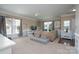 Bright living room featuring neutral colors, large windows, and comfortable seating at 4915 Juniper Grove Sw Ct, Concord, NC 28027