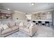 Spacious living room featuring a neutral color palette, comfortable sofa, and built-in shelves at 4915 Juniper Grove Sw Ct, Concord, NC 28027