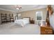 Spacious main bedroom featuring a tray ceiling, a ceiling fan, two windows, and neutral decor at 4915 Juniper Grove Sw Ct, Concord, NC 28027