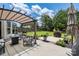 Outdoor patio features comfortable seating, a fire pit table, a beautiful lawn, and a cozy pergola at 4915 Juniper Grove Sw Ct, Concord, NC 28027
