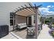 Inviting patio area with comfortable seating and a pergola, ideal for outdoor relaxation and entertainment at 4915 Juniper Grove Sw Ct, Concord, NC 28027
