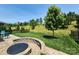 Spacious backyard featuring a stone fire pit and well-maintained lawn and landscaping at 5003 Looking Glass Trl, Denver, NC 28037