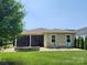Beautiful backyard featuring a patio, outdoor seating, and lush green lawn at 5003 Looking Glass Trl, Denver, NC 28037