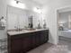 Elegant bathroom with double vanity, granite countertops, and neutral tiling with modern fixtures at 5003 Looking Glass Trl, Denver, NC 28037