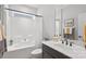 Clean bathroom featuring a bathtub with shower and a dark vanity with a white basin at 5003 Looking Glass Trl, Denver, NC 28037