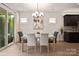 Dining room with glass top table, pendant lighting, and view of backyard via sliding glass doors at 5003 Looking Glass Trl, Denver, NC 28037