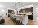 Stylish kitchen featuring dark cabinets, an island with seating, and stainless steel appliances at 5003 Looking Glass Trl, Denver, NC 28037