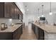 Long, large kitchen with island featuring granite countertops, subway tile backsplash, and stainless steel appliances at 5003 Looking Glass Trl, Denver, NC 28037