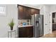 Convenient kitchenette with dark wood cabinets, stainless steel refrigerator and granite countertop at 5003 Looking Glass Trl, Denver, NC 28037