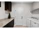 Well-equipped laundry room featuring shelving, white appliances, and a granite countertop at 5003 Looking Glass Trl, Denver, NC 28037