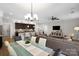 Open-concept living room with modern kitchen, granite countertops, and a spacious seating area at 5003 Looking Glass Trl, Denver, NC 28037