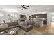 Open-concept living area with a large kitchen island, dining area, and comfortable living space at 5003 Looking Glass Trl, Denver, NC 28037