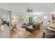 Open concept living room with hardwood flooring, view of kitchen and dinning room at 5003 Looking Glass Trl, Denver, NC 28037