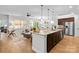 Spacious living room with ample natural light, hardwood floors, and a view of the open concept kitchen at 5003 Looking Glass Trl, Denver, NC 28037