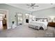 Spacious bedroom featuring soft carpet, a large mirror, and a comfortable bench at 5003 Looking Glass Trl, Denver, NC 28037