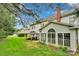 Large grassy backyard with a covered outdoor patio and an enclosed sun room at 508 Whitehead Ct # 328, Fort Mill, SC 29708