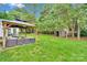 Lush backyard with patio, outdoor seating and a storage shed surrounded by mature trees at 508 Whitehead Ct # 328, Fort Mill, SC 29708