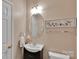 Tastefully decorated half-bathroom features a vanity sink, decorative mirror, and modern fixtures in a neutral color palette at 508 Whitehead Ct # 328, Fort Mill, SC 29708