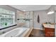 Modern bathroom featuring a soaking tub, glass enclosed shower, and double vanity at 508 Whitehead Ct # 328, Fort Mill, SC 29708