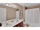 Neutral bathroom featuring double sink vanity, wall art, framed mirror, shower with white curtain, and a toilet at 508 Whitehead Ct # 328, Fort Mill, SC 29708