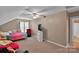 Spacious carpeted bedroom featuring ceiling fan, closet, sitting area, and natural light at 508 Whitehead Ct # 328, Fort Mill, SC 29708