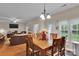 Bright dining area with wood floors, a chandelier, and views into the living room and backyard at 508 Whitehead Ct # 328, Fort Mill, SC 29708