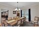 Formal dining room featuring a chandelier, wainscoting, and a large table with seating for six at 508 Whitehead Ct # 328, Fort Mill, SC 29708