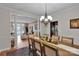 Open-concept dining room with wood floors, a chandelier, and access to the living room and kitchen at 508 Whitehead Ct # 328, Fort Mill, SC 29708