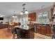 Updated kitchen featuring an island with cooktop, granite countertops, stainless steel appliances, and open to the breakfast area at 508 Whitehead Ct # 328, Fort Mill, SC 29708