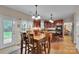 Open-concept kitchen and dining area featuring cherry cabinets, an island cooktop, and stainless steel appliances at 508 Whitehead Ct # 328, Fort Mill, SC 29708
