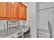 Functional laundry room features modern appliances, overhead cabinets, and ample storage space for household needs at 508 Whitehead Ct # 328, Fort Mill, SC 29708