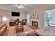 Cozy living room with a brick fireplace, ceiling fan, and ample seating for relaxation at 508 Whitehead Ct # 328, Fort Mill, SC 29708