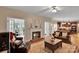 Cozy living room features a fireplace, hardwood floors, and a comfortable seating area with access to the kitchen and sunroom at 508 Whitehead Ct # 328, Fort Mill, SC 29708
