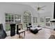 Bright sun room boasts a ceiling fan, tile floors, an arched window, and access to an outdoor space at 508 Whitehead Ct # 328, Fort Mill, SC 29708