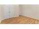 A bedroom with wood floors, neutral walls, and white doors at 527 Livingston Dr, Lancaster, SC 29720