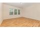 A bedroom with wood floors, neutral walls, and a window at 527 Livingston Dr, Lancaster, SC 29720