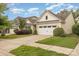 Exterior street view of a charming home with manicured landscaping and an attached garage at 527 Livingston Dr, Lancaster, SC 29720