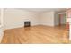 Open-concept living room with hardwood floors and a fireplace, adjacent to kitchen at 527 Livingston Dr, Lancaster, SC 29720