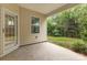 Covered patio with concrete floor and view of the backyard, accessed through a glass door at 527 Livingston Dr, Lancaster, SC 29720