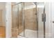 A shower with brown tiles and a glass door at 527 Livingston Dr, Lancaster, SC 29720