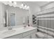 Bright bathroom with a double sink vanity, ample counter space, and a shower and tub combination at 5324 Somerset Hill Ln, Charlotte, NC 28269