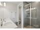 This bathroom features double sinks, a glass shower and updated fixtures at 5324 Somerset Hill Ln, Charlotte, NC 28269