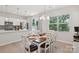 Bright dining area features a stylish table with white chairs and modern chandelier lighting fixture at 5324 Somerset Hill Ln, Charlotte, NC 28269